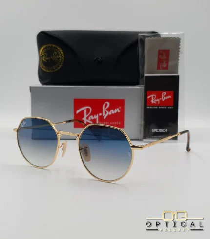 Lunettes de soleil Ray-Ban Jack RB3565 dorées avec verres dégradés bleus, étui noir, boîte grise et livret de garantie chez Optical Gallery.