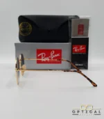 Lunettes de soleil Ray-Ban Jack RB3565 dorées avec verres dégradés bleus, étui noir, boîte grise et livret de garantie chez Optical Gallery.