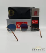 Lunettes de soleil Ray-Ban Jack RB3565 dorées avec verres dégradés bleus, étui noir, boîte grise et livret de garantie chez Optical Gallery.