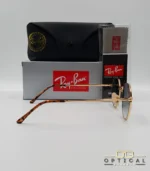 Lunettes de soleil Ray-Ban Jack RB3565 dorées avec verres dégradés bleus, étui noir, boîte grise et livret de garantie chez Optical Gallery.