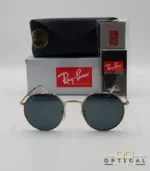 Lunettes de soleil Ray-Ban Jack RB3565 dorées avec verres noirs, étui noir, boîte grise et livret de garantie chez Optical Gallery.