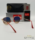 Lunettes de soleil Ray-Ban Scuderia Ferrari RB3602M noires et dorées avec verres dégradés marrons, étui noir, boîte grise et livret de garantie chez Optical Gallery.