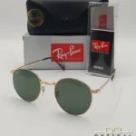 Lunettes de soleil Ray-Ban New Round RB3637 dorées avec verres verts G-15, étui noir, boîte grise et livret de garantie chez Optical Gallery.
