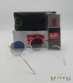 Lunettes de soleil Ray-Ban New Round RB3637 dorées avec verres dégradés bleus gris, étui noir, boîte grise et livret de garantie chez Optical Gallery.