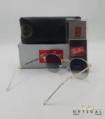 Lunettes de soleil Ray-Ban New Round RB3637 dorées avec verres dégradés bleus gris, étui noir, boîte grise et livret de garantie chez Optical Gallery.