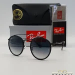 Lunettes de soleil Ray-Ban Round Double Bridge RB3647N noires avec cerclages en acétate noir et verres dégradés bleus gris, étui noir, boîte grise et livret de garantie chez Optical Gallery.