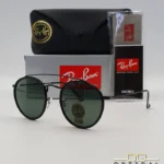 Lunettes de soleil Ray-Ban Round Double Bridge RB3647N noires avec cerclages en acétate noir et verres verts G-15, étui noir, boîte grise et livret de garantie chez Optical Gallery.