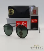 Lunettes de soleil Ray-Ban Round Double Bridge RB3647N noires avec cerclages en acétate noir et verres verts G-15, étui noir, boîte grise et livret de garantie chez Optical Gallery.
