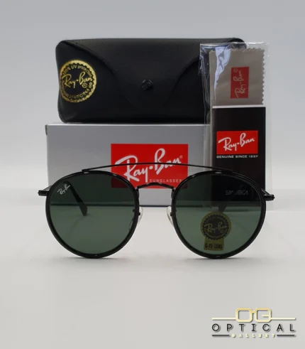 Lunettes de soleil Ray-Ban Round Double Bridge RB3647N noires avec cerclages en acétate noir et verres verts G-15, étui noir, boîte grise et livret de garantie chez Optical Gallery.