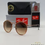 Lunettes de soleil Ray-Ban Round Double Bridge RB3647N marrons avec cerclages en acétate transparent marron et verres dégradés marrons, étui noir, boîte grise et livret de garantie chez Optical Gallery.