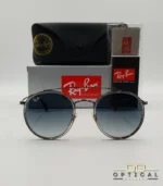 Lunettes de soleil Ray-Ban Round Double Bridge RB3647N gris anthracite avec cerclages en acétate transparent et verres dégradés bleus, étui noir, boîte grise et livret de garantie chez Optical Gallery.