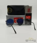 Lunettes de soleil Ray-Ban Round Double Bridge RB3647N gris anthracite avec cerclages en acétate transparent et verres dégradés bleus, étui noir, boîte grise et livret de garantie chez Optical Gallery.