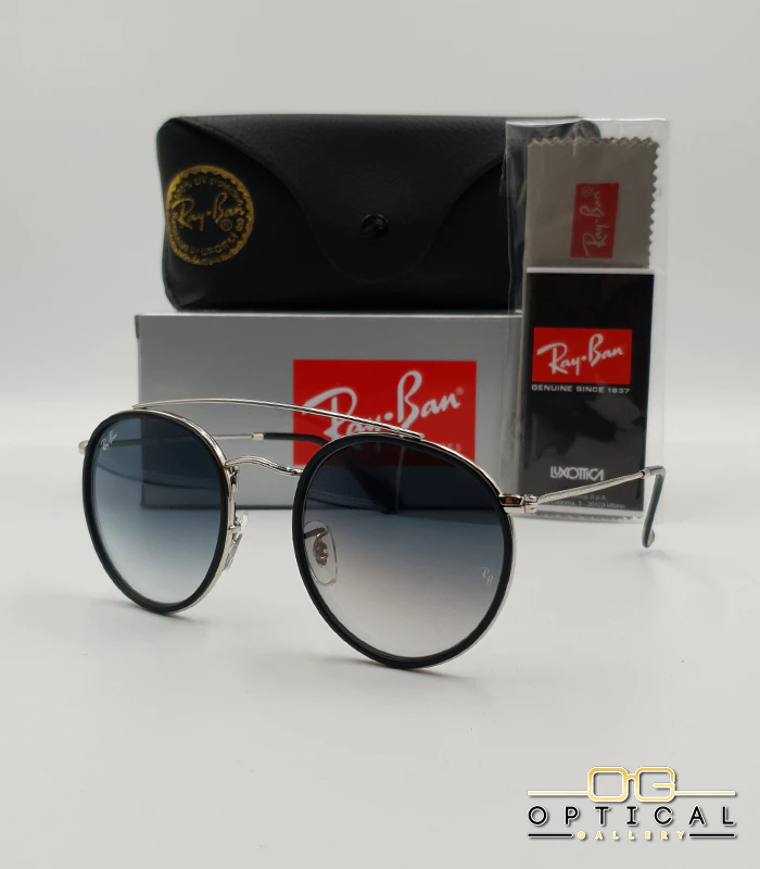 lunettes-de-soleil-ray-ban-round-double-bridge-rb3647n-argent-noir-bleu-degrade-optical-gallery Lunettes de soleil Ray-Ban Round Double Bridge RB3647N argentées avec cerclages en acétate noir et verres dégradés bleus gris, étui noir, boîte grise et livret de garantie chez Optical Gallery.