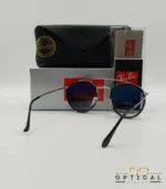 Lunettes de soleil Ray-Ban Round Double Bridge RB3647N argentées avec cerclages en acétate noir et verres dégradés bleus gris, étui noir, boîte grise et livret de garantie chez Optical Gallery.