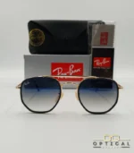 Lunettes de soleil Ray-Ban Marshal II RB3648M dorées avec cerclages en acétate bleu marine et verres dégradés bleus gris, étui noir, boîte grise et livret de garantie chez Optical Gallery.