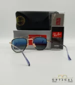 Lunettes de soleil Ray-Ban Marshal II RB3648M dorées avec cerclages en acétate bleu marine et verres dégradés bleus gris, étui noir, boîte grise et livret de garantie chez Optical Gallery.