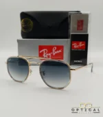 Lunettes de soleil Ray-Ban Marshal II RB3648M dorées avec cerclages en acétate transparent et verres dégradés bleus gris, étui noir, boîte grise et livret de garantie chez Optical Gallery.