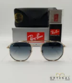 Lunettes de soleil Ray-Ban Marshal II RB3648M dorées avec cerclages en acétate transparent et verres dégradés bleus gris, étui noir, boîte grise et livret de garantie chez Optical Gallery.