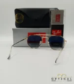 Lunettes de soleil Ray-Ban Marshal II RB3648M dorées avec cerclages en acétate transparent et verres dégradés bleus gris, étui noir, boîte grise et livret de garantie chez Optical Gallery.