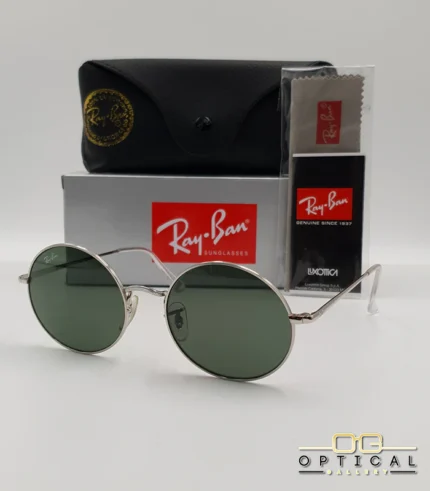 Lunettes de soleil rondes Ray-Ban RB1970 dorées avec verres verts, présentées avec leur étui en cuir noir, leur boîte et le logo Optical Gallery.