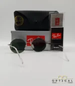 Lunettes de soleil rondes Ray-Ban RB1970 dorées avec verres verts, présentées avec leur étui en cuir noir, leur boîte et le logo Optical Gallery.
