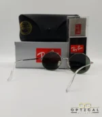 Lunettes de soleil rondes Ray-Ban RB1970 dorées avec verres verts, présentées avec leur étui en cuir noir, leur boîte et le logo Optical Gallery.