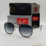 Lunettes de soleil Ray-Ban Marshal II RB3648M argentées avec cerclages en acétate noir et verres dégradés bleus gris, étui noir, boîte grise et livret de garantie chez Optical Gallery.