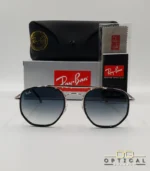 Lunettes de soleil Ray-Ban Marshal II RB3648M argentées avec cerclages en acétate noir et verres dégradés bleus gris, étui noir, boîte grise et livret de garantie chez Optical Gallery.