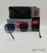 Lunettes de soleil Ray-Ban Marshal II RB3648M argentées avec cerclages en acétate noir et verres dégradés bleus gris, étui noir, boîte grise et livret de garantie chez Optical Gallery.