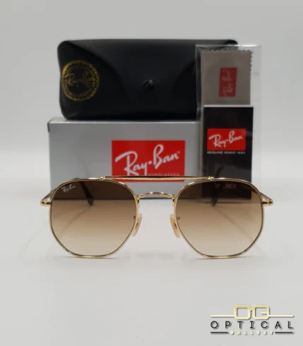 Lunettes de soleil Ray-Ban Marshal II RB3648M dorées avec verres dégradés marrons, étui noir, boîte grise et livret de garantie chez Optical Gallery.