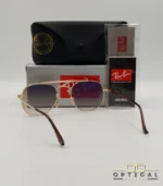 Lunettes de soleil Ray-Ban Marshal II RB3648M dorées avec verres dégradés marrons, étui noir, boîte grise et livret de garantie chez Optical Gallery.