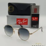 Lunettes de soleil Ray-Ban Julie RB3772 dorées avec verres dégradés bleus gris, étui noir, boîte grise et livret de garantie chez Optical Gallery.