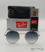 Lunettes de soleil Ray-Ban Julie RB3772 dorées avec verres dégradés bleus gris, étui noir, boîte grise et livret de garantie chez Optical Gallery.