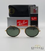 Lunettes de soleil Ray-Ban Round Double Bridge RB3847N dorées avec cerclages en acétate écaille de tortue et verres verts G-15, étui noir, boîte grise et livret de garantie chez Optical Gallery.